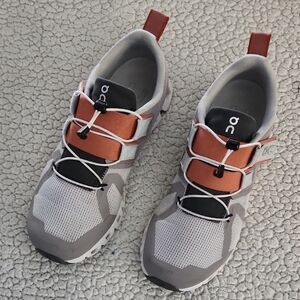 On Running Shoes with Orange and Gray Accents